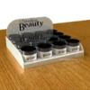 White acrylic cosmetic display with 15 Timeless Beauty jars and branded header