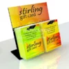 A black acrylic countertop stand displaying Stirling gift cards using eurohooks, complete with a bold branded header card.