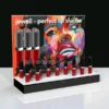 Acrylic display plinth showcasing red and black lipsticks with an A3 upright graphic featuring vibrant artwork of a woman's face.