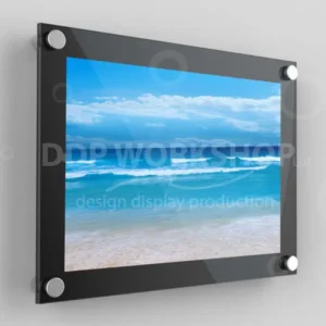 Black wall-mounted poster frame displaying a vibrant ocean scene, secured with four satin silver standoffs.