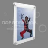 Wall-mounted acrylic picture frame with rounded corners, displaying an image of a skydiver mid-air against a grey background.