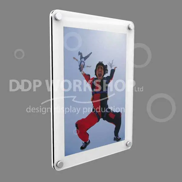 Wall-mounted acrylic picture frame with rounded corners, displaying an image of a skydiver mid-air against a grey background.