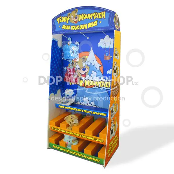 Vibrant cardboard display stand with cartoon teddy bear theme, featuring euro hooks and shelf compartments for showcasing plush toys and accessories.