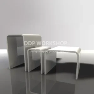 Set of three white acrylic bridge risers with polished edges, arranged by size on a glossy surface.