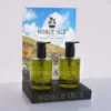 Point of sale display stand with two green pump bottles and an A4 graphic insert reading “Noble Isle”.