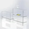 Two clear acrylic tables with integrated shelves and polished edges, ideal for modern interiors or retail displays.