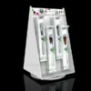White acrylic rotating display stand with hanging packaged cosmetic brushes and a branded header graphic.