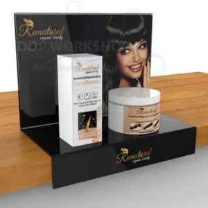 Black acrylic countertop display stand showcasing beauty products with a promotional graphic panel and branded shelf lip.
