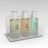 Frosted acrylic toiletries tray holding three small Health & Spa bottles in a neat, wave-front design.