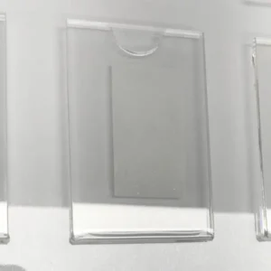 Clear acrylic photo pocket with a semicircle thumb cutout, designed to hold 50x74mm portrait images.