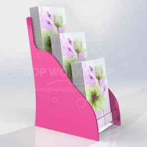 Bright pink acrylic 3-tier card stand holding A5 portrait floral greeting cards, displayed on a countertop.