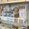 Mug display bridge showcasing mugs and coasters in a retail gift shop setting