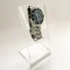 Clear acrylic stand presenting a single luxury wristwatch at an angled view