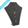 Black acrylic jewellery display stand showcasing three necklaces and three pairs of earrings on a sleek, mannequin-style form.