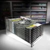 Clear acrylic countertop dump bin filled with magazines in a retail setting