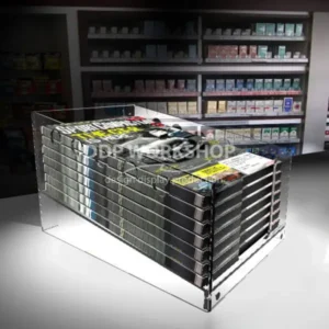 Clear acrylic countertop dump bin filled with magazines in a retail setting