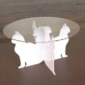 acrylic cupcake stand with a scalloped clear top plate supported by four white acrylic cat silhouettes.