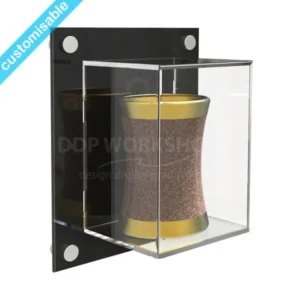 Small clear Perspex wall-mounted display case with a black back panel, showcasing a gold-trimmed brown object. Satin silver fixings visible at the corners.