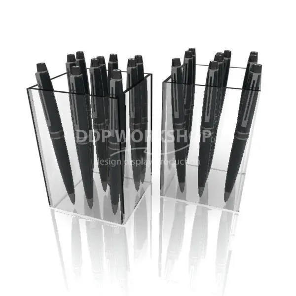 Clear acrylic tub display holding multiple black pens in a vertical arrangement.