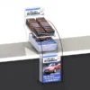 Clear acrylic teardrop display stand showcasing magazines and confectionery with branded header