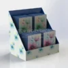 Compact floral-themed 2-tier cardboard card display on a countertop, holding vertical greeting cards with elegant botanical designs.