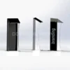 Trio of clear and black acrylic lecterns with branding panel and angled top for note display