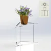 Clear acrylic Florence Corner Table with a single shelf, holding a flower pot and designed with a triangular shape to fit neatly into corners.