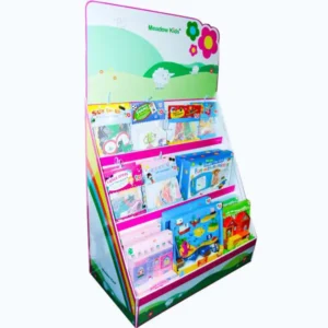 Freestanding cardboard display unit with three tiered shelves holding colourful children’s books and activity packs, featuring a Meadow Kids-branded header.