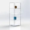Clear acrylic 4-shelf display case with hinged doors and minimalist design, containing a few decorative items on individual shelves.