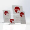 Set of clear acrylic lean-back tabletop POS holders displaying red "SALE!" signs in various sizes.