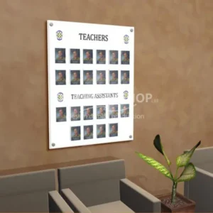 Wall-mounted organisation photo board with labeled sections for "Teachers" and "Teaching Assistants," each containing clear pockets with staff photos.