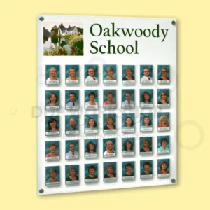 Wall-mounted staff photo board featuring multiple rows of portrait photos in clear acrylic pockets with vinyl header graphics.