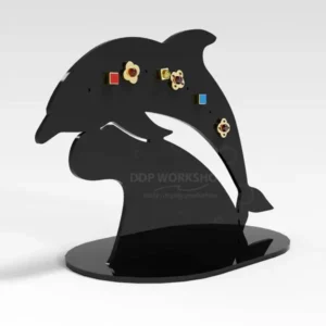 Black acrylic dolphin-shaped earring stand displaying multiple pairs of stud earrings
