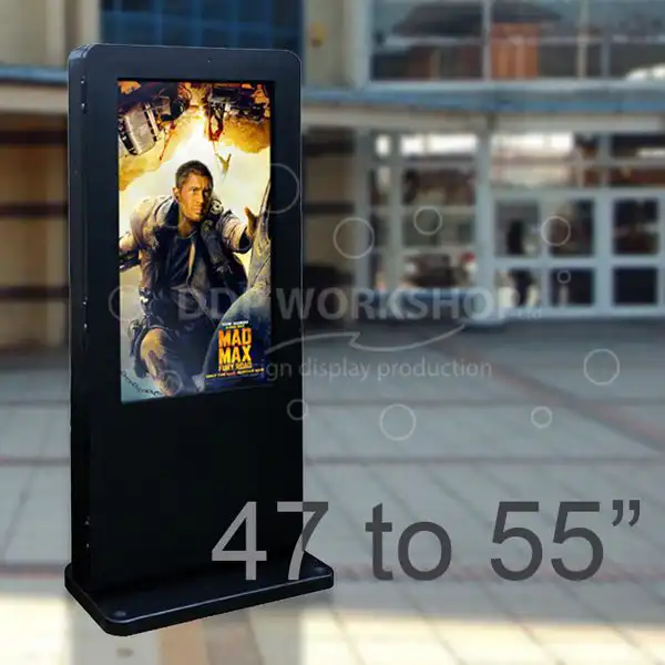 Freestanding outdoor digital totem with a 47 to 55-inch display screen showing a movie poster in front of a modern glass building.